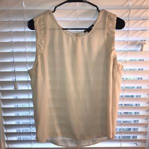 Cream colored sleeveless blouse